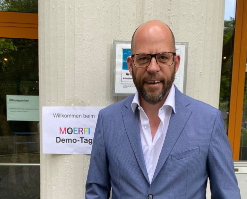 Markus Deimann vor dem Schild "Willkommen beim MOERFI Demo-Tag"